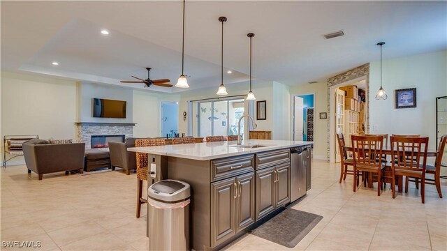 2541 SW 32nd Ln, Cape Coral, FL 33914 - kitchen featuring a sink, stainless steel dishwasher, a ceiling fan, light countertops, and a kitchen island with sink