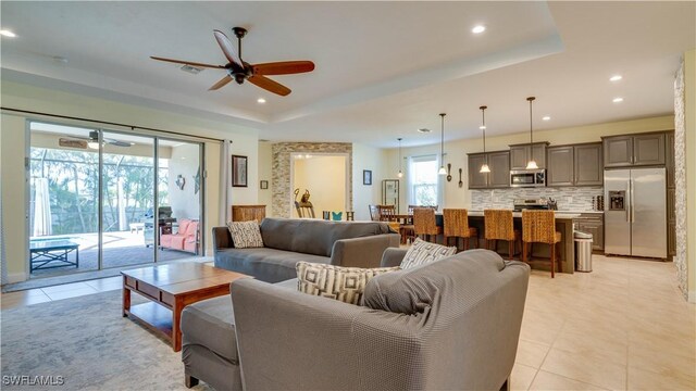 2541 SW 32nd Ln, Cape Coral, FL 33914 - living room with ceiling fan, light tile patterned floors, a tray ceiling, and recessed lighting