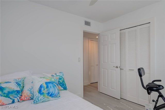 3905 Del Prado Blvd S Unit D-101, Cape Coral, FL 33904 - bedroom with light wood-style floors, ceiling fan, and a closet