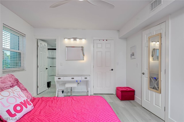 3905 Del Prado Blvd S Unit D-101, Cape Coral, FL 33904 - bedroom with light wood-style floors, baseboards, ceiling fan, and ensuite bath