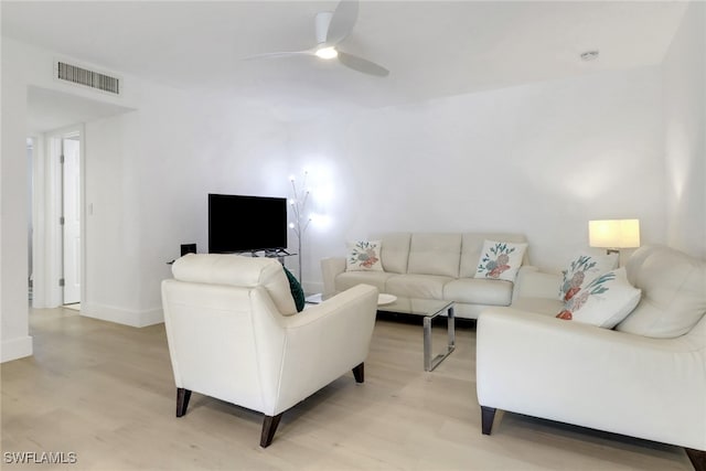 3905 Del Prado Blvd S Unit D-101, Cape Coral, FL 33904 - living room with light wood-style flooring, ceiling fan, and baseboards