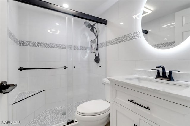3905 Del Prado Blvd S Unit D-101, Cape Coral, FL 33904 - bathroom with tile walls, a stall shower, vanity, and toilet