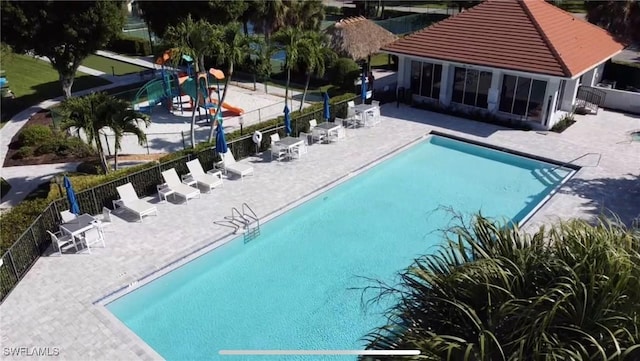 25560 Springtide Ct, Bonita Springs, FL 34135 - community pool featuring a patio area and fence