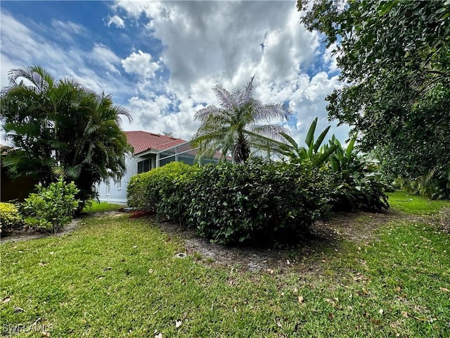 25560 Springtide Ct, Bonita Springs, FL 34135 - view of green lawn with a lanai