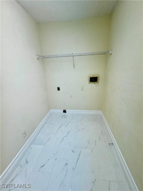 25560 Springtide Ct, Bonita Springs, FL 34135 - laundry room with hookup for an electric dryer, marble finish floors, and baseboards
