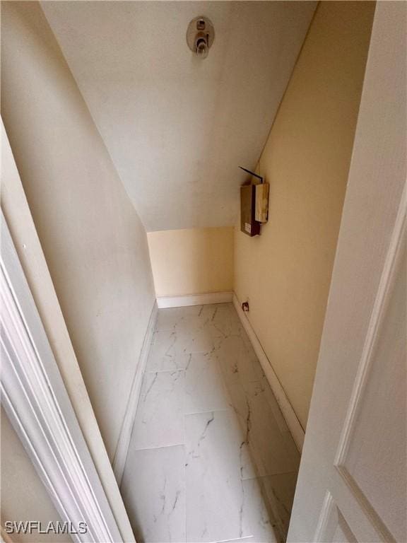 25560 Springtide Ct, Bonita Springs, FL 34135 - bathroom featuring marble look tile flooring, vaulted ceiling, and baseboards