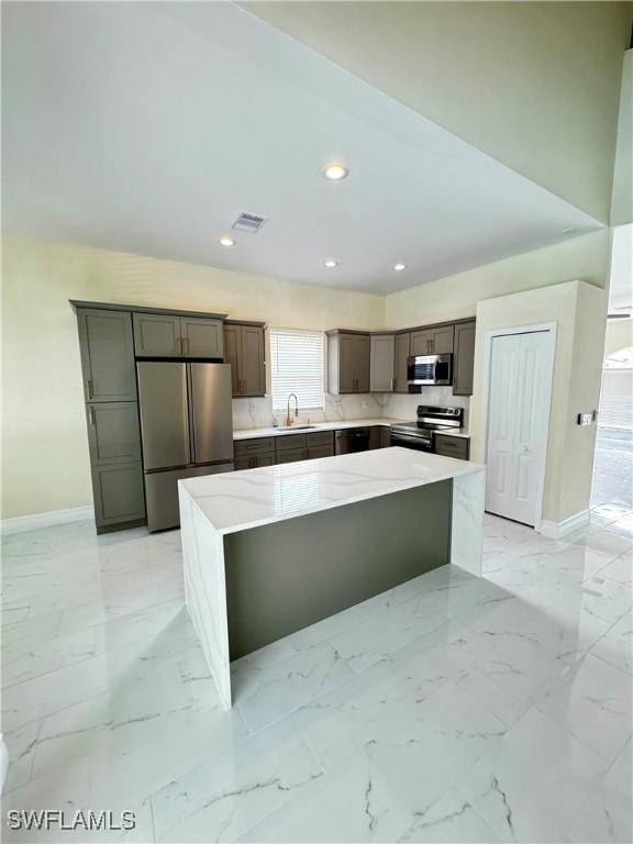 25560 Springtide Ct, Bonita Springs, FL 34135 - kitchen with stainless steel appliances, a sink, a center island, baseboards, and recessed lighting