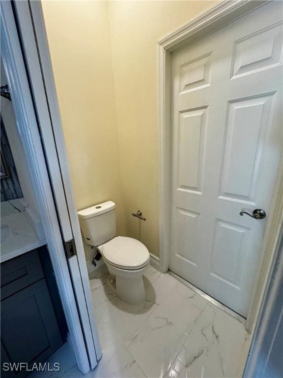25560 Springtide Ct, Bonita Springs, FL 34135 - bathroom with toilet and marble finish flooring