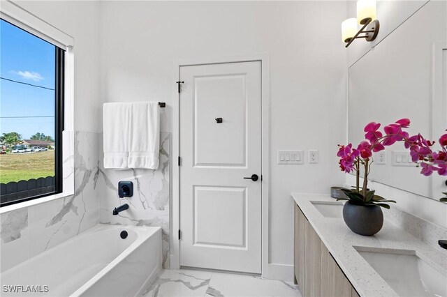 1917 NW 24th Ave, Cape Coral, FL 33993 - full bathroom with marble look tiles, double vanity, a bath, and baseboards