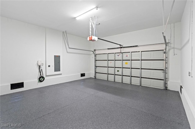 1917 NW 24th Ave, Cape Coral, FL 33993 - garage with electric panel, a garage door opener, and baseboards