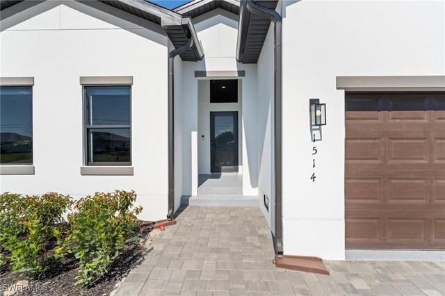 2308 NW 5th St, Cape Coral, FL 33993 - property entrance with stucco siding and a garage