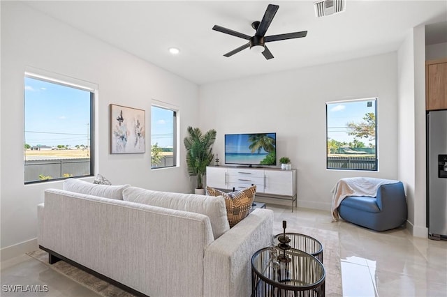 2308 NW 5th St, Cape Coral, FL 33993 - living room with healthy amount of natural light, baseboards, and a ceiling fan