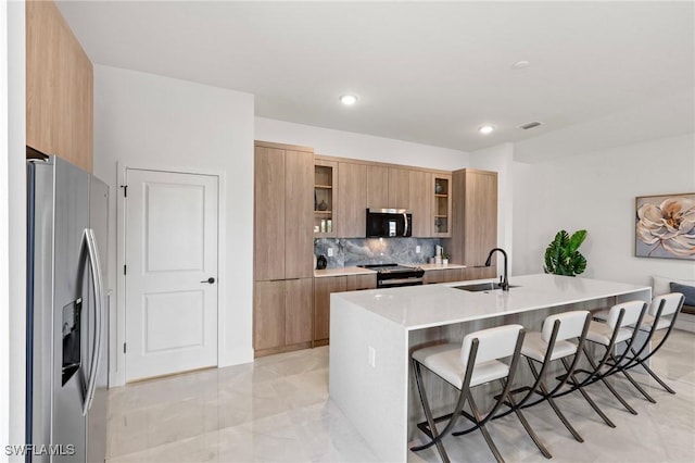 2308 NW 5th St, Cape Coral, FL 33993 - kitchen featuring stainless steel appliances, modern cabinets, a sink, a breakfast bar, and recessed lighting