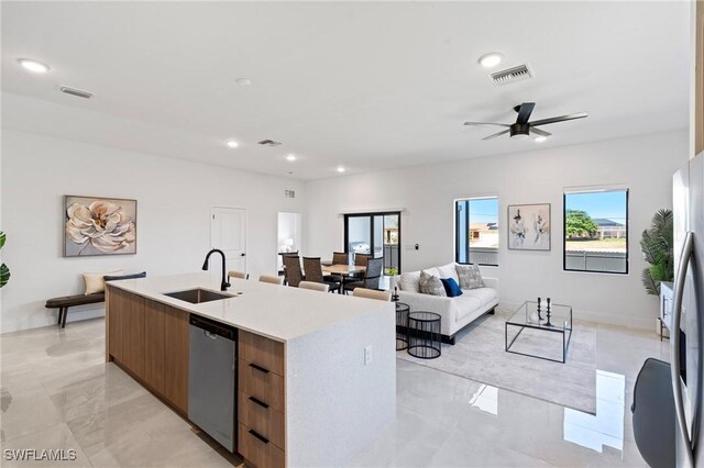 2308 NW 5th St, Cape Coral, FL 33993 - kitchen featuring a sink, modern cabinets, stainless steel dishwasher, a center island with sink, and light countertops