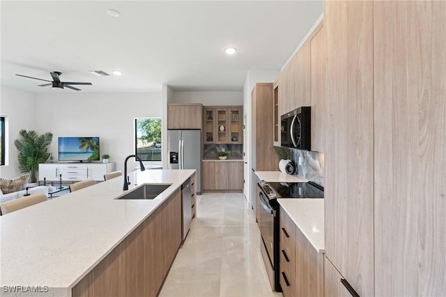 2308 NW 5th St, Cape Coral, FL 33993 - kitchen with stainless steel appliances, a sink, modern cabinets, open floor plan, and a large island