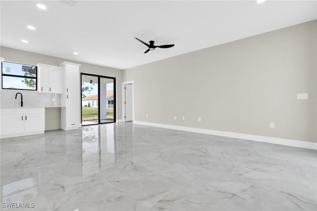 290731 St St W, Lehigh Acres, FL 33971 - unfurnished living room featuring plenty of natural light, recessed lighting, light marble finish floors, and baseboards
