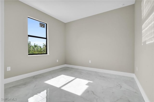 290731 St St W, Lehigh Acres, FL 33971 - empty room featuring marble look tile flooring and baseboards