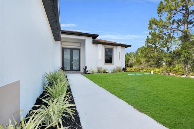 290731 St St W, Lehigh Acres, FL 33971 - doorway to property with french doors, stucco siding, and a lawn