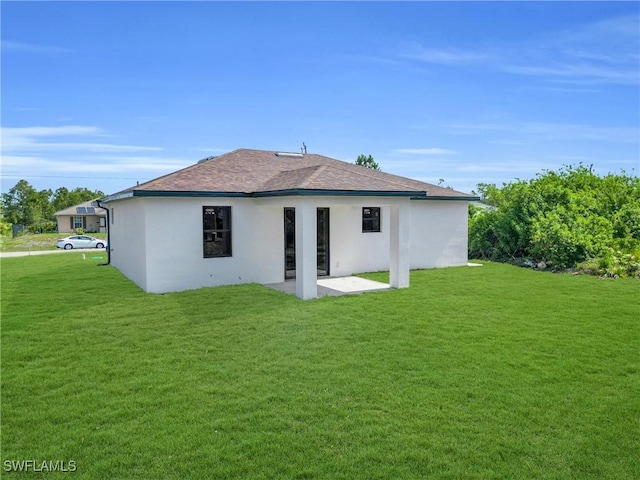 290731 St St W, Lehigh Acres, FL 33971 - rear view of house with a patio area, a yard, stucco siding, and a shingled roof