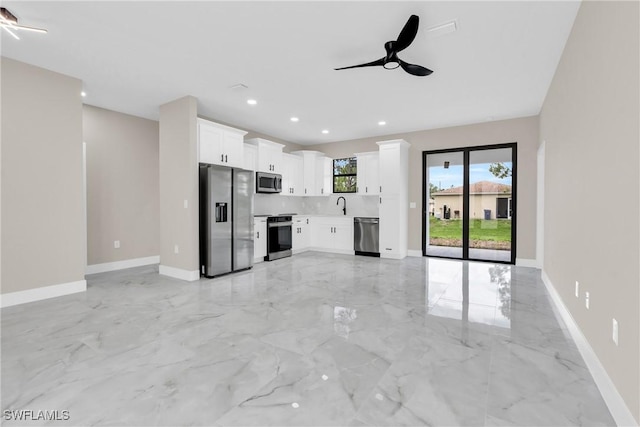 290731 St St W, Lehigh Acres, FL 33971 - unfurnished living room featuring light marble finish floors, a ceiling fan, baseboards, a sink, and recessed lighting