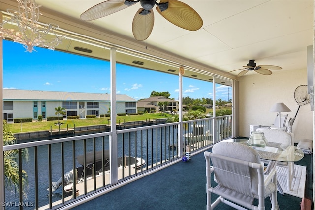 1345 SE 40th Ter Unit 2D, Cape Coral, FL 33904 - sunroom featuring a water view, a chandelier, and a residential view