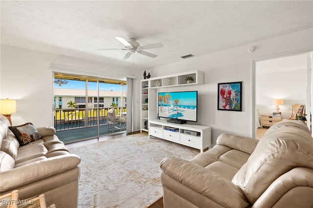 1345 SE 40th Ter Unit 2D, Cape Coral, FL 33904 - living area with a textured ceiling and a ceiling fan