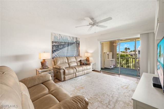 1345 SE 40th Ter Unit 2D, Cape Coral, FL 33904 - living area with a ceiling fan, a textured ceiling, and wood finished floors