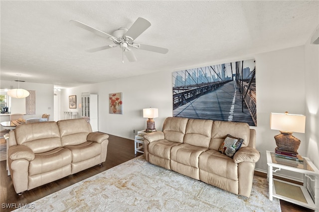1345 SE 40th Ter Unit 2D, Cape Coral, FL 33904 - living area featuring wood finished floors, a ceiling fan, baseboards, and a textured ceiling