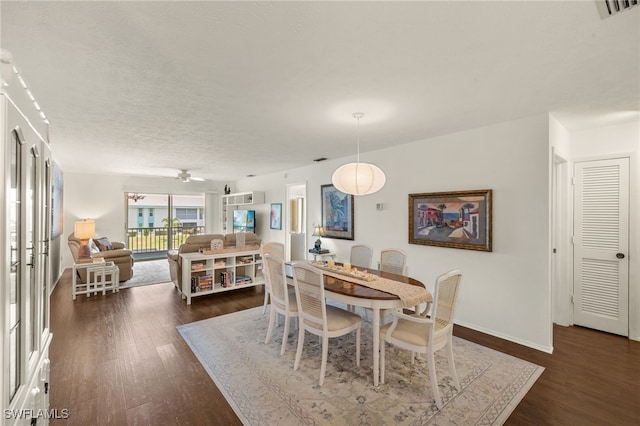 1345 SE 40th Ter Unit 2D, Cape Coral, FL 33904 - dining room with dark wood-style flooring, baseboards, and ceiling fan
