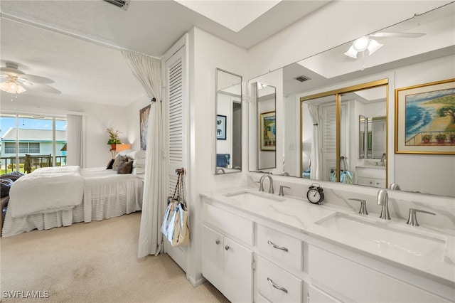 1345 SE 40th Ter Unit 2D, Cape Coral, FL 33904 - ensuite bathroom with ceiling fan and double vanity