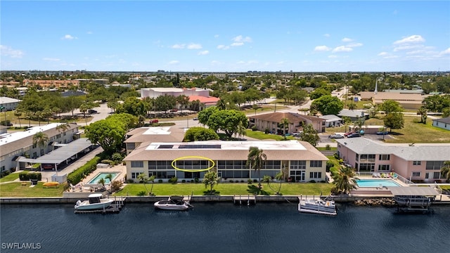 1345 SE 40th Ter Unit 2D, Cape Coral, FL 33904 - drone / aerial view of a pool and a large body of water