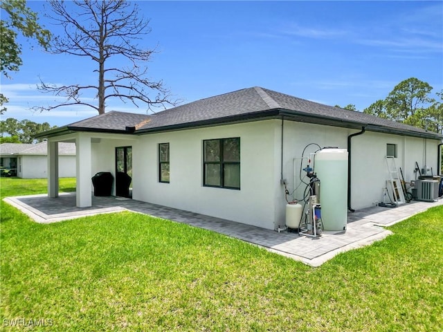 1914 Sunniland Blvd, Lehigh Acres, FL 33971 - rear view of house with stucco siding, a patio area, a yard, and central air condition unit