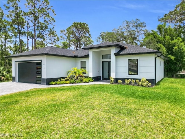 1914 Sunniland Blvd, Lehigh Acres, FL 33971 - prairie-style home featuring a garage, stucco siding, a front lawn, a shingled roof, and driveway