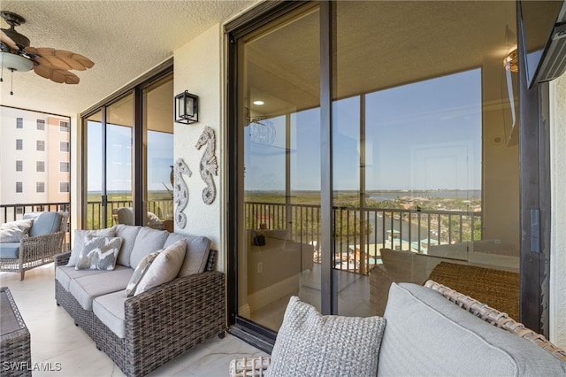 5793 Cape Harbour Dr Unit 1119, Cape Coral, FL 33914 - sunroom / solarium with ceiling fan, a wall of windows, outdoor lounge area, and a textured ceiling