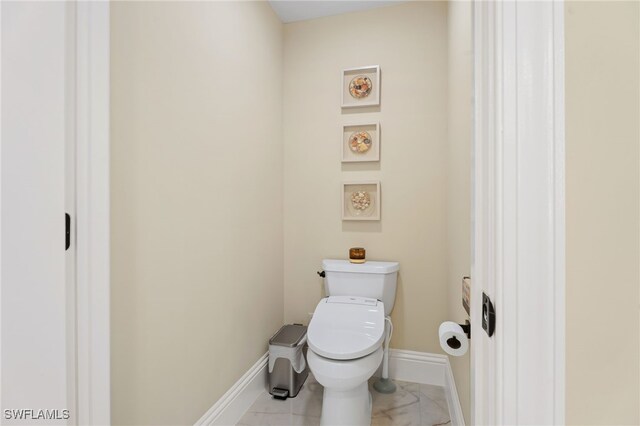 5793 Cape Harbour Dr Unit 1119, Cape Coral, FL 33914 - bathroom featuring toilet, baseboards, and marble finish floors