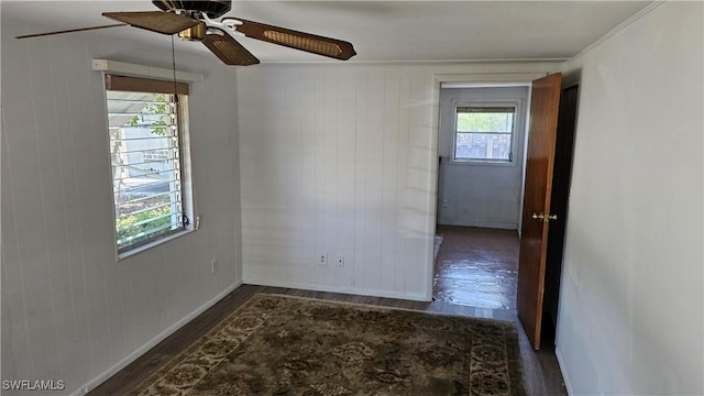 27625 Michigan St, Bonita Springs, FL 34135 - unfurnished room featuring wood finished floors, ceiling fan, baseboards, and wood walls