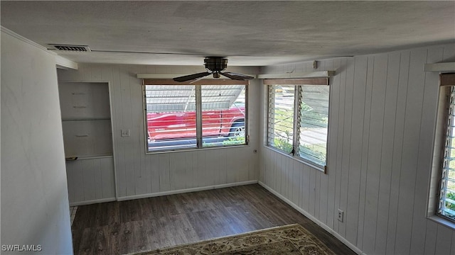 27625 Michigan St, Bonita Springs, FL 34135 - empty room featuring wood finished floors, baseboards, a ceiling fan, and wood walls