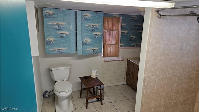 27625 Michigan St, Bonita Springs, FL 34135 - bathroom featuring toilet, tile patterned flooring, vanity, and tile walls