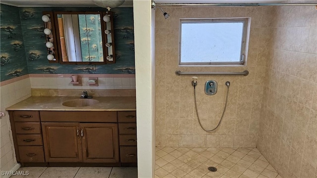 27625 Michigan St, Bonita Springs, FL 34135 - bathroom featuring a tile shower, vanity, and tile patterned flooring
