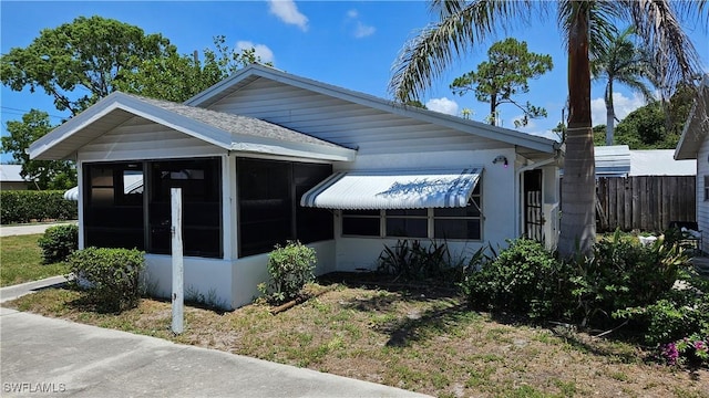 27625 Michigan St, Bonita Springs, FL 34135 - view of side of home with a sunroom and roof with shingles