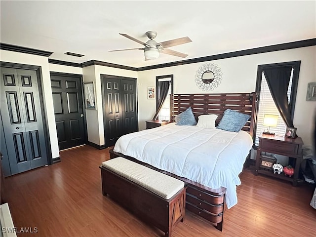 352 Paisley Ave, Lehigh Acres, FL 33974 - bedroom featuring crown molding, wood finished floors, multiple windows, multiple closets, and ceiling fan