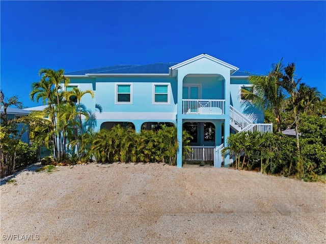 518 Avenida Primiceria, Marathon, FL 33050 - beach home featuring stairs, a porch, a carport, dirt driveway, and stucco siding