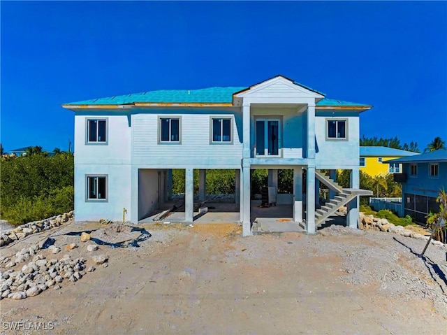 518 Avenida Primiceria, Marathon, FL 33050 - back of house featuring a carport, stairs, and a patio