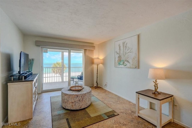 5000 Estero Blvd Unit 202, Fort Myers Beach, FL 33931 - living room with a textured ceiling and baseboards