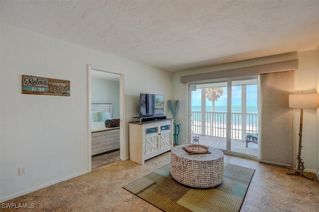 5000 Estero Blvd Unit 202, Fort Myers Beach, FL 33931 - living area with a textured ceiling and baseboards
