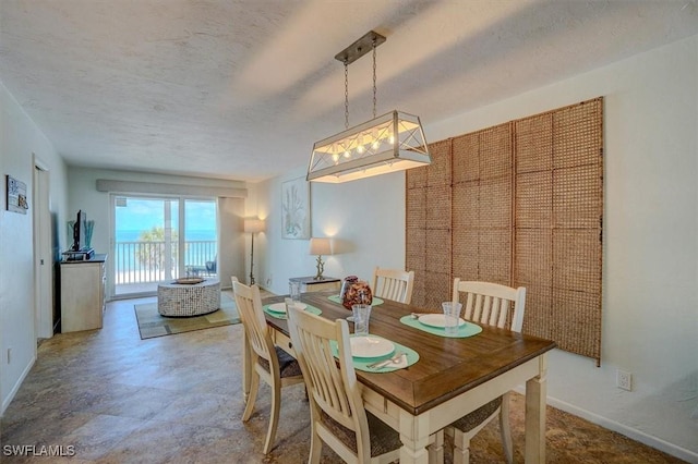 5000 Estero Blvd Unit 202, Fort Myers Beach, FL 33931 - dining space with baseboards and a textured ceiling