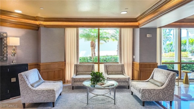 4021 Gulf Shore Blvd N Unit 1704, Naples, FL 34103 - living area featuring crown molding, a wainscoted wall, a decorative wall, carpet floors, and wallpapered walls