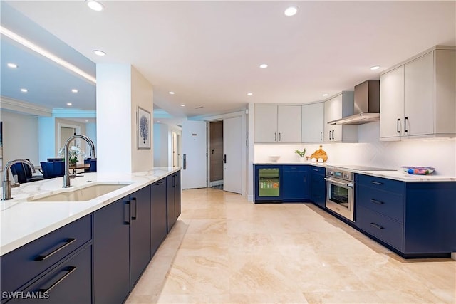 4021 Gulf Shore Blvd N Unit 1704, Naples, FL 34103 - kitchen with wall chimney exhaust hood, a sink, beverage cooler, oven, and recessed lighting