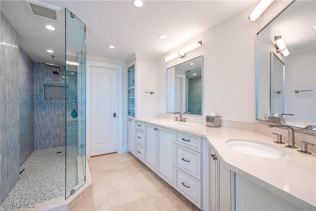 4021 Gulf Shore Blvd N Unit 1704, Naples, FL 34103 - full bathroom featuring a shower stall, double vanity, recessed lighting, and tile patterned floors