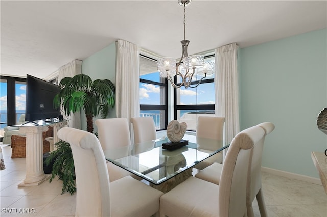 300 S Collier Blvd Unit 2304, Marco Island, FL 34145 - dining space featuring a chandelier, light tile patterned flooring, and baseboards